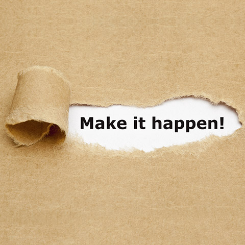 Make it happen! appearing behind torn brown paper